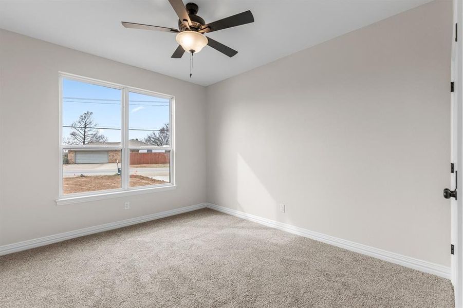 Unfurnished room featuring ceiling fan and carpet Unfurnished room featuring ceiling fan and carpet