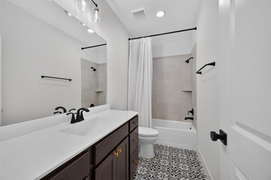 Ideally located on the second floor just outside the spacious game room, this beautifully appointed full bathroom features clean lines, modern finishes, and a bright, inviting atmosphere. Thoughtfully designed to serve the upstairs living spaces and secondary / third bedrooms, it offers both everyday convenience and timeless style.