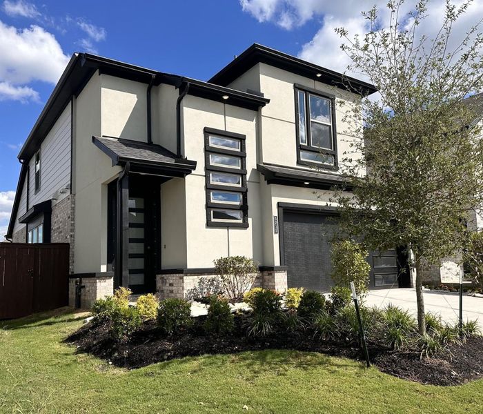 Front exterior of a new home in Meridiana 40', 65', Iowa Colony, TX, highlighting curb appeal (Image 1).