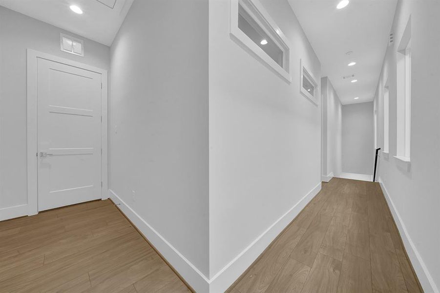 This hall leads from the primary suite down to the secondary bedrooms.