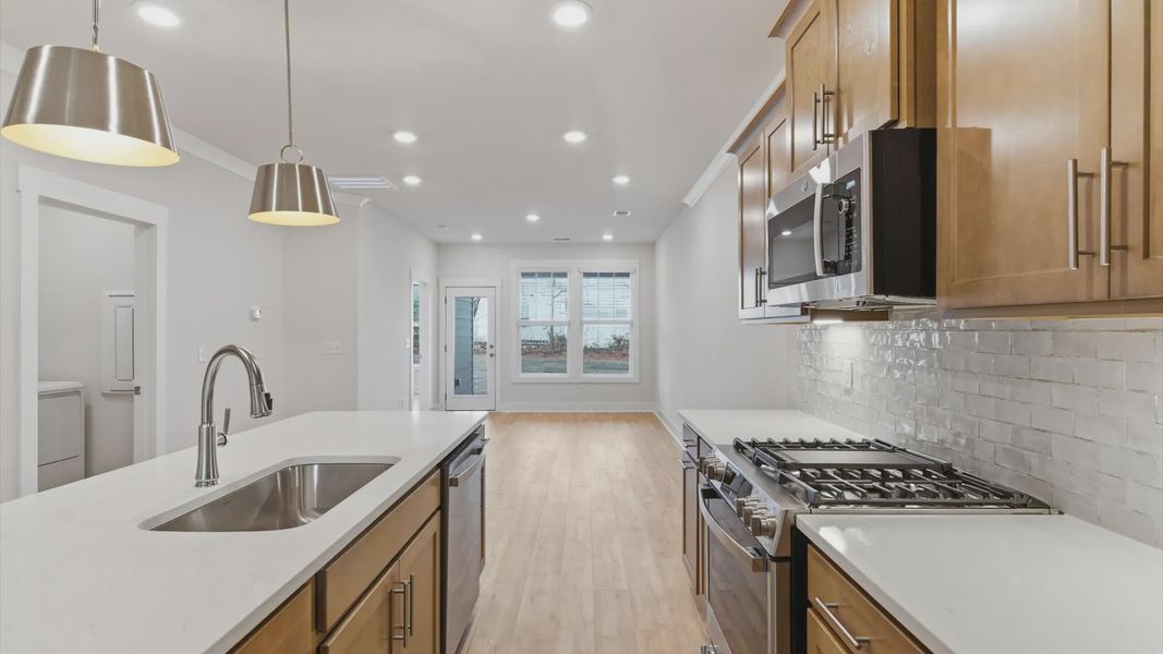 Accomplished kitchen design featuring pendant lighting above a statement island for both prep and gathering in Greenville, SC