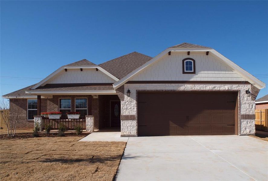 View of front of house featuring a porch and a garage