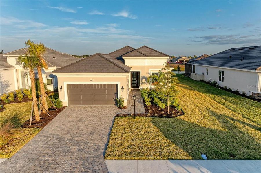 Front exterior of a new home in Esplanade at Azario Lakewood Ranch, Lakewood Ranch, FL, highlighting curb appeal (Image 2). Front exterior of a new home in Esplanade at Azario Lakewood Ranch, Lakewood Ranch, FL, highlighting curb appeal (Image 2).