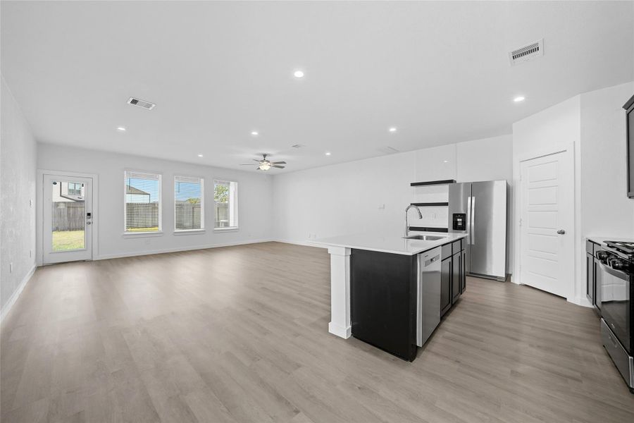 The open concept living, kitchen and dining is perfect for entertaining and the windows bring in a beautiful amount of natural light.