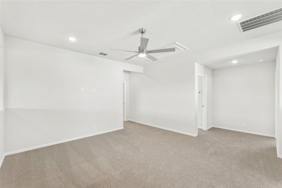 Empty room with beige carpet, white walls, ceiling fan, and recessed lighting Empty room with beige carpet, white walls, ceiling fan, and recessed lighting