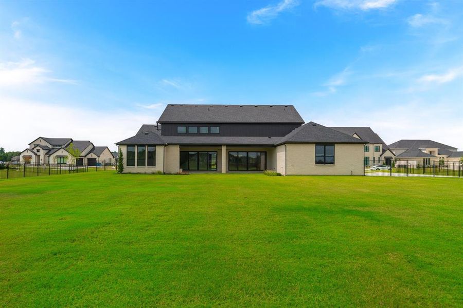 Rear view of house with a yard