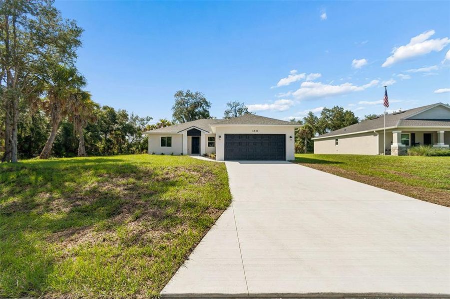 Front exterior of a new home in , North Port, FL, highlighting curb appeal (Image 20). Front exterior of a new home in , North Port, FL, highlighting curb appeal (Image 20).