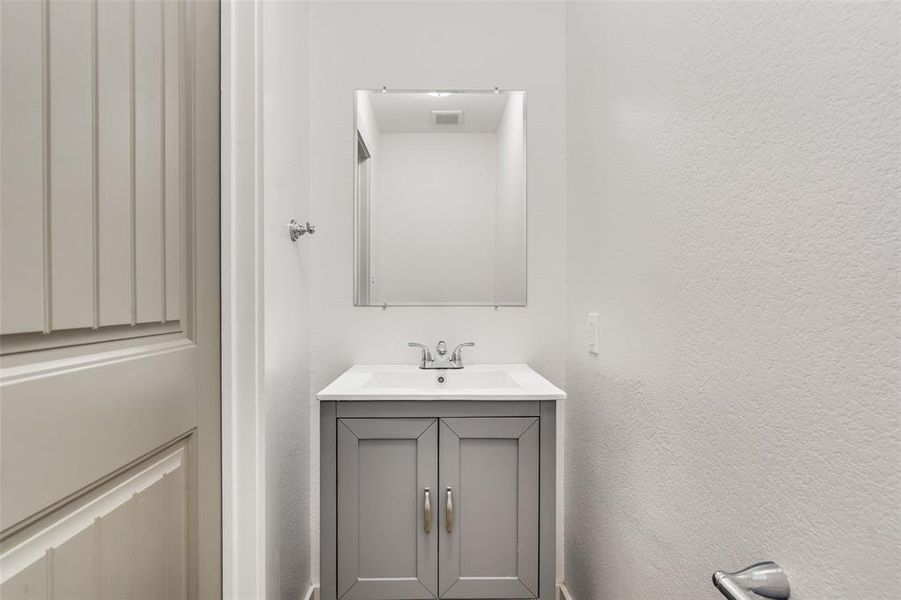 Half bath off of the kitchen and main living area for guests.