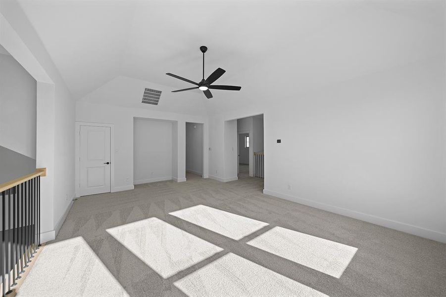 Unfurnished bedroom featuring light colored carpet, a ceiling fan, and lofted ceiling