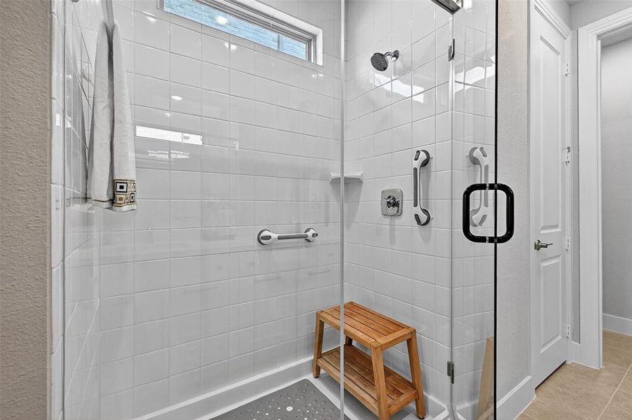 Bathroom featuring a shower stall and tile patterned floors Bathroom featuring a shower stall and tile patterned floors