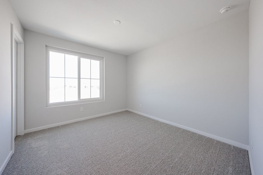 A room with a window and carpet. A room with a window and carpet.