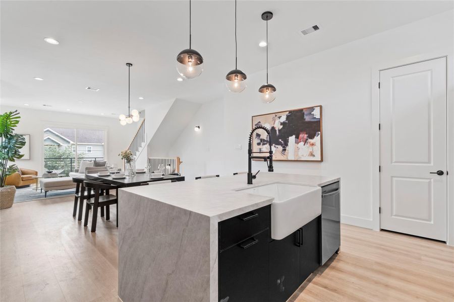 From the kitchen, you can easily connect with guests in the dining and living areas, keeping conversations flowing throughout the open space. From the kitchen, you can easily connect with guests in the dining and living areas, keeping conversations flowing throughout the open space.