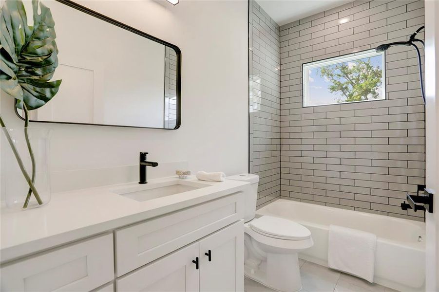 The 2nd full bath has a tub/shower combo with tile surround.