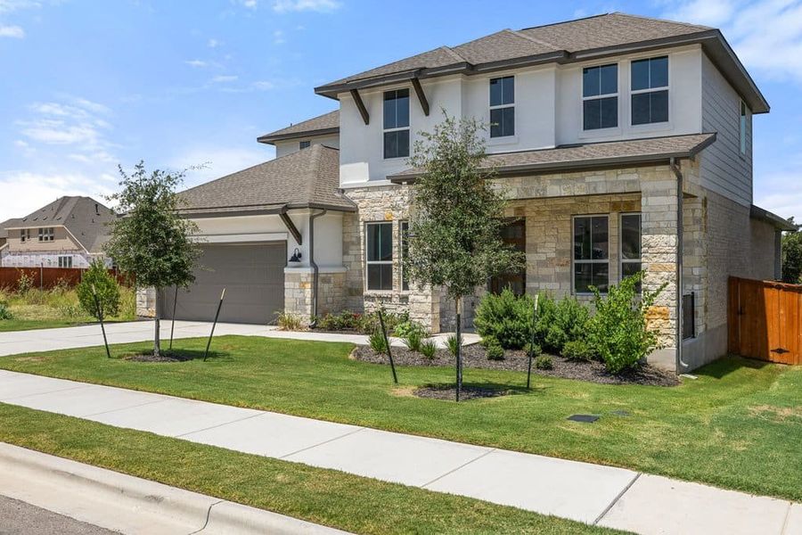 Front exterior of a new home in Lariat, Liberty Hill, TX, highlighting curb appeal (Image 26).