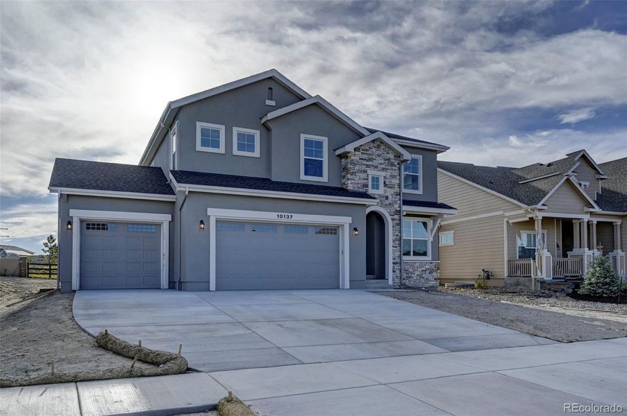 Front exterior of a new home in , Colorado Springs, CO, highlighting curb appeal (Image 1). Front exterior of a new home in , Colorado Springs, CO, highlighting curb appeal (Image 1).
