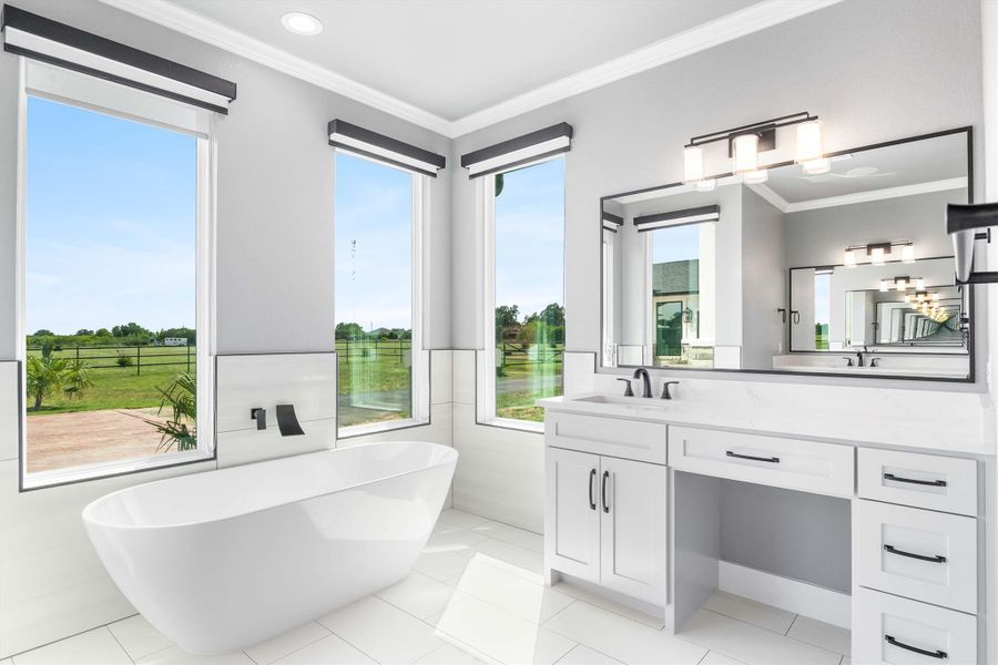 Bathroom with double vanity, a freestanding bath, crown molding, and tile patterned floors Bathroom with double vanity, a freestanding bath, crown molding, and tile patterned floors