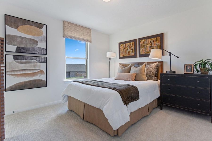Additional secondary bedroom featuring plush carpet flooring, neutral toned walls, lighting, large window and closet!