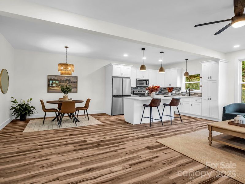 Looking from the front door into the open living room, dining area and kitchen