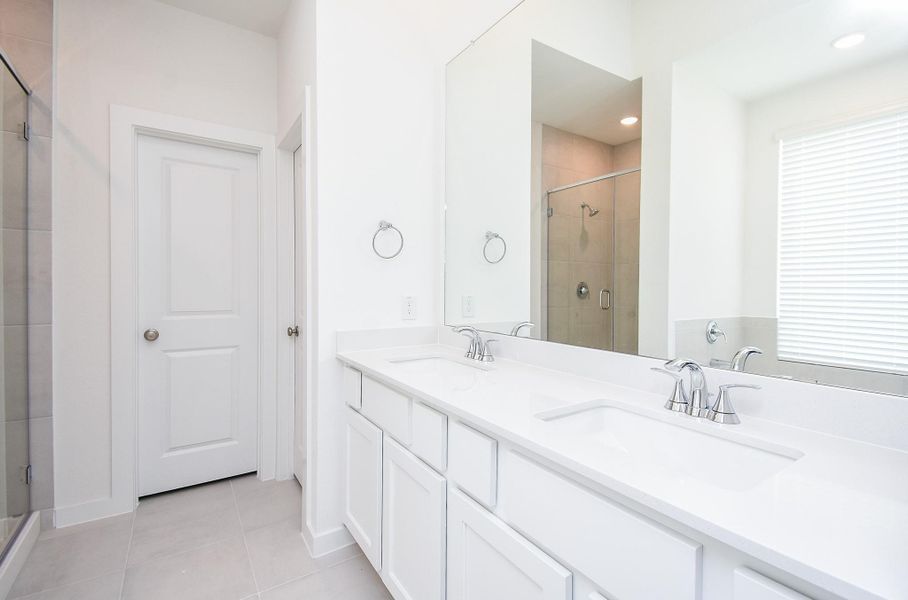 Here's a nice wide, reflected view of the primary bath, with shower and tub (below the window), shown here.