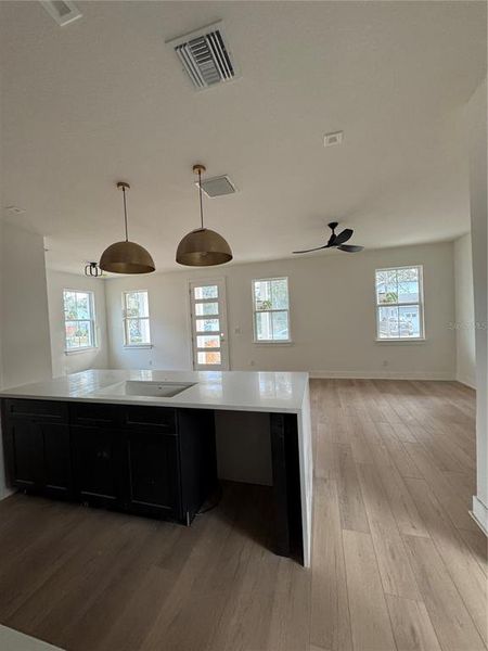 View from garage: kitchen with living and dining room in background