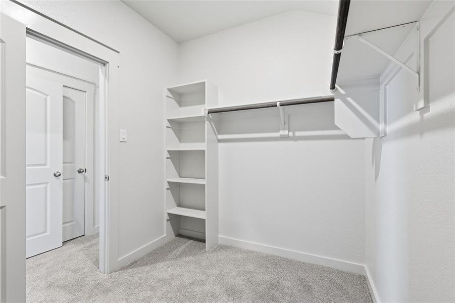 Walk in closet with light colored carpet Walk in closet with light colored carpet
