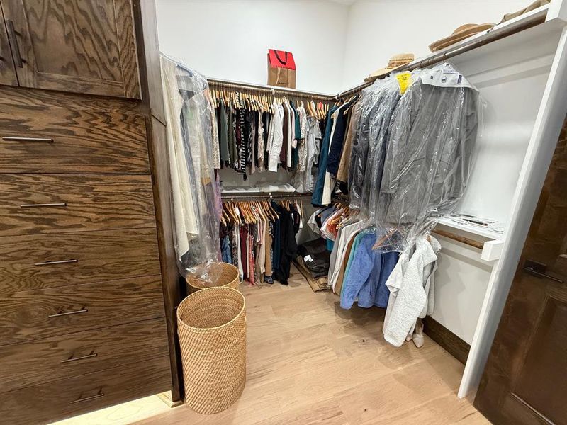 Spacious closet with light wood-style floors