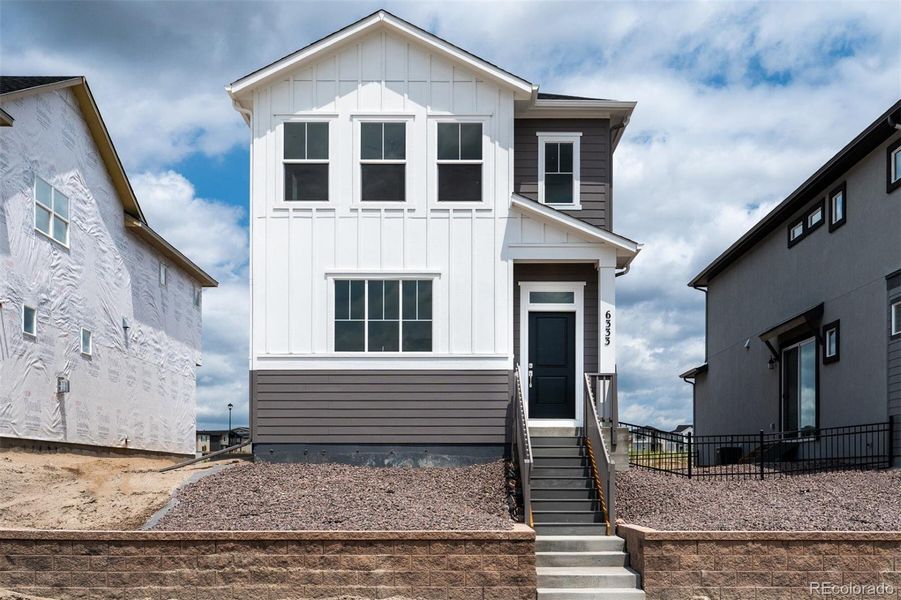 Front exterior of a new home in Revel Crossing at Wolf Ranch – The Ascent Collection, Colorado Springs, CO, highlighting curb appeal (Image 20).