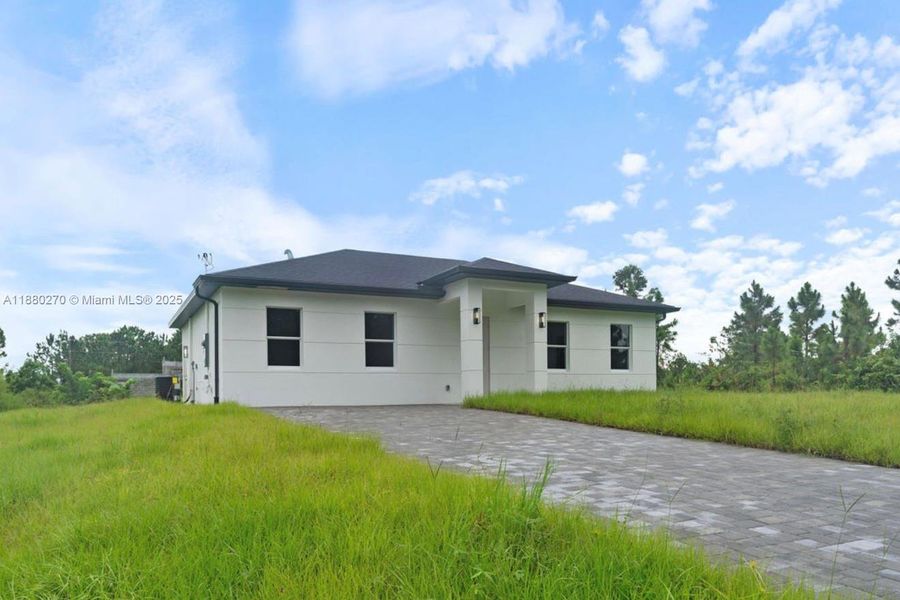 Front exterior of a new home in , Lehigh Acres, FL, highlighting curb appeal (Image 1). Front exterior of a new home in , Lehigh Acres, FL, highlighting curb appeal (Image 1).