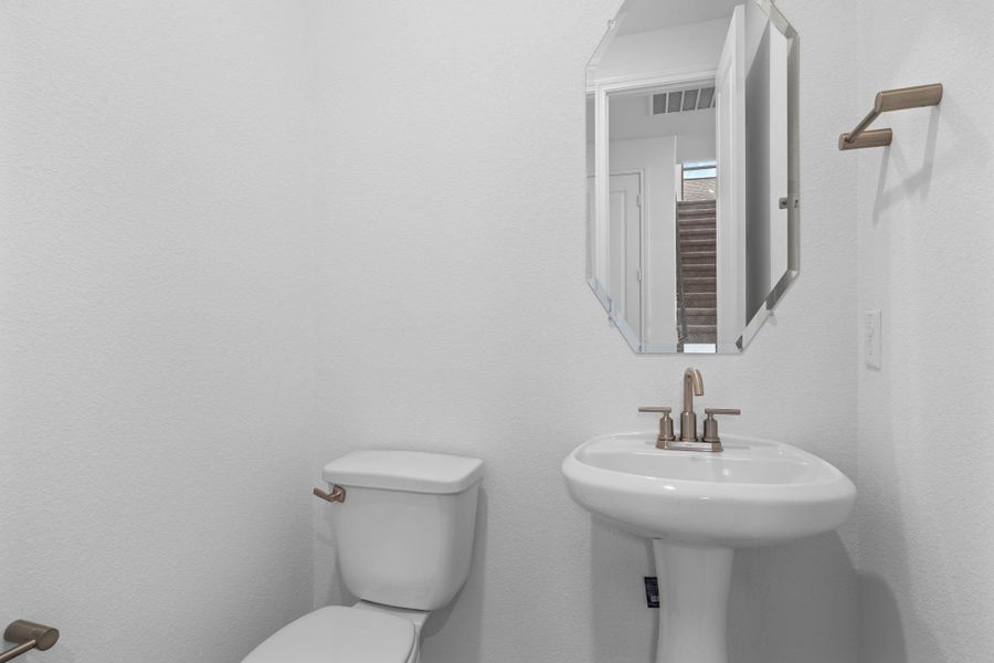 This charming home features a beautifully appointed half bath adjacent to the family room, perfect for welcoming guests and adding convenience to your daily life.