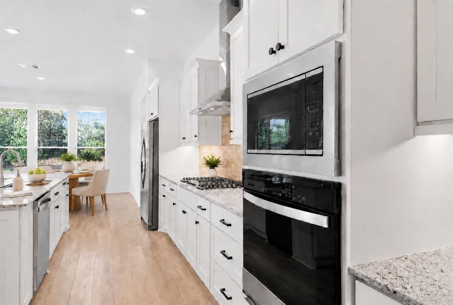 Virtually Staged. Culinary delights await in this bright kitchen, complete with modern appliances and ample counter space. Virtually Staged. Culinary delights await in this bright kitchen, complete with modern appliances and ample counter space.