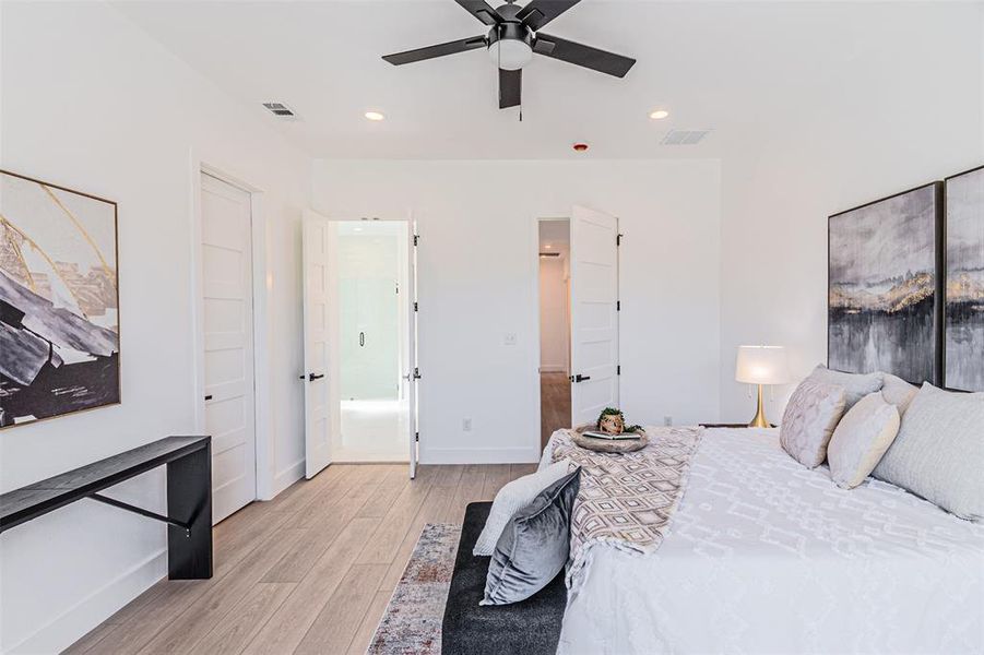 Bedroom featuring light wood-style floors, recessed lighting, and a ceiling fan Bedroom featuring light wood-style floors, recessed lighting, and a ceiling fan