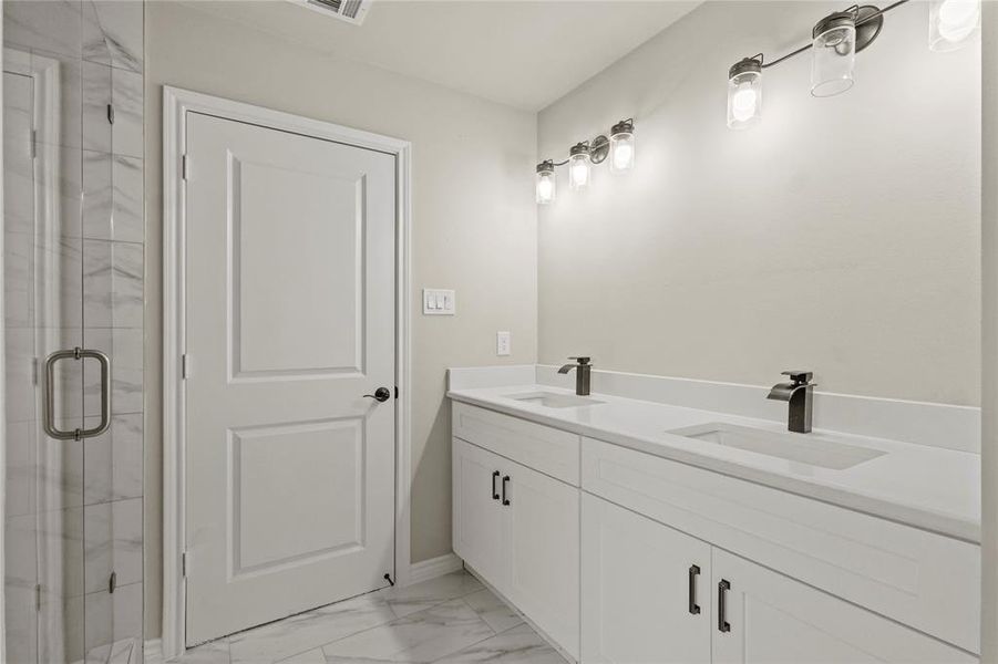 Bathroom with vanity and an enclosed shower