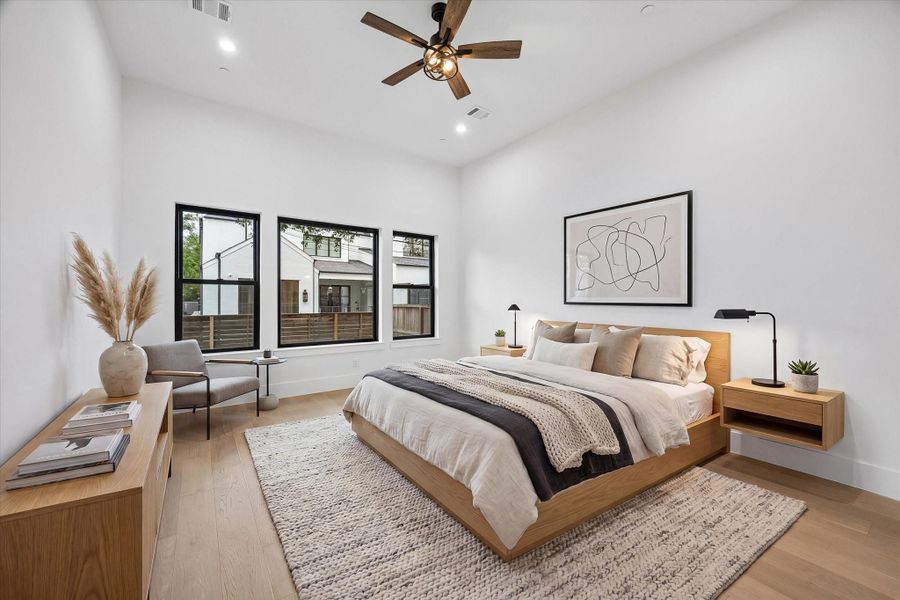 The first floor Primary bedroom is also endowed with good light from its 12-foot ceiling and set of three large windows.(virt. staged)