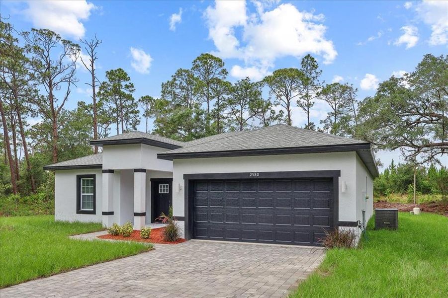 Front exterior of a new home in , Indian Lake Estates, FL, highlighting curb appeal (Image 2). Front exterior of a new home in , Indian Lake Estates, FL, highlighting curb appeal (Image 2).