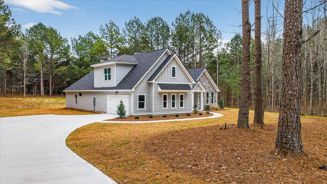 Front exterior of a new home in White Oaks, The Rock, GA, highlighting curb appeal (Image 25). Front exterior of a new home in White Oaks, The Rock, GA, highlighting curb appeal (Image 25).
