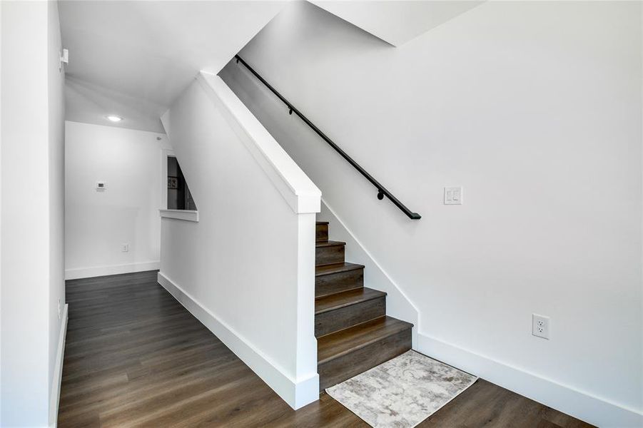 Staircase with dark wood-type flooring