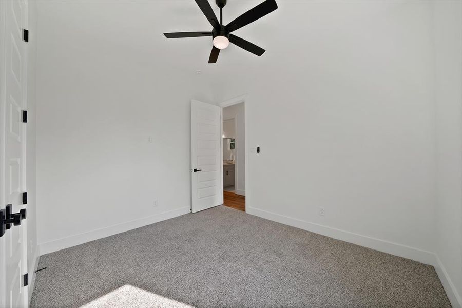 Unfurnished bedroom featuring carpet and a ceiling fan Unfurnished bedroom featuring carpet and a ceiling fan