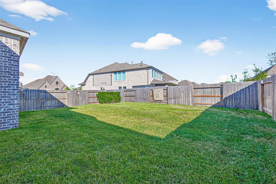 Spacious backyard offering room for outdoor activities, gardening projects, and entertaining visitors. Spacious backyard offering room for outdoor activities, gardening projects, and entertaining visitors.