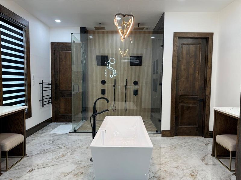 Full bathroom featuring vanity, a soaking tub, a stall shower, recessed lighting, and light marble finish floors