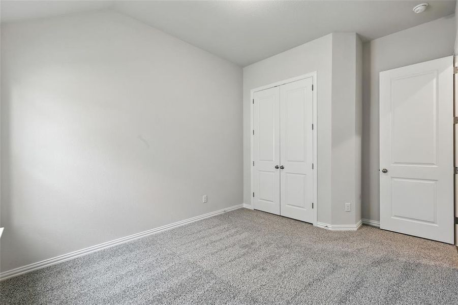 Unfurnished bedroom featuring carpet floors and a closet