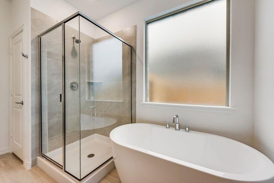 Bathroom featuring a wealth of natural light and independent shower and bath