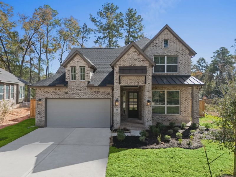Front exterior of a new home in The Woodlands Hills, Willis, TX, highlighting curb appeal (Image 15).