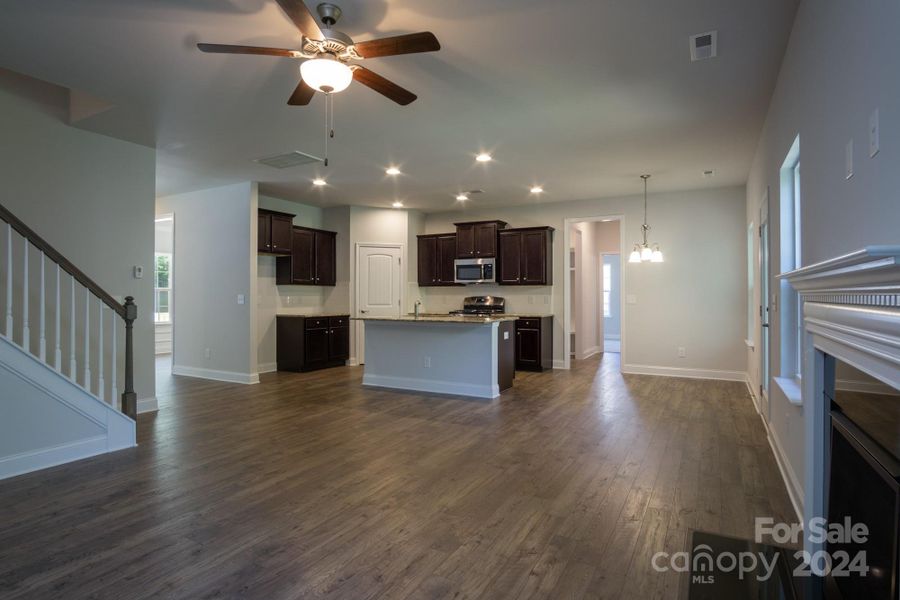 Family Room into Kitchen. Photo representation. Colors and options will differ.