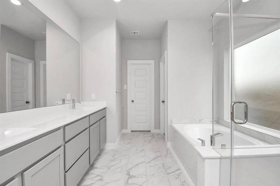 Experience a spa-like escape right in the heart of your primary bathroom. Sample photo of completed home with similar floor plan. Actual colors and selections may vary.