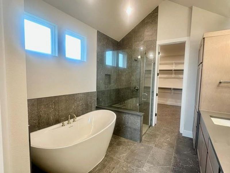 A modern bathroom showcases a freestanding tub and a spacious glass-enclosed shower. A modern bathroom showcases a freestanding tub and a spacious glass-enclosed shower.