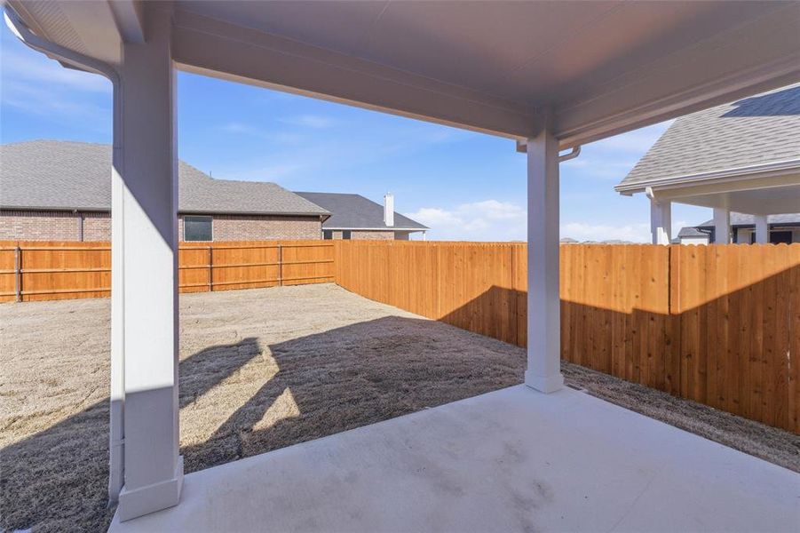 Fenced backyard featuring a patio area