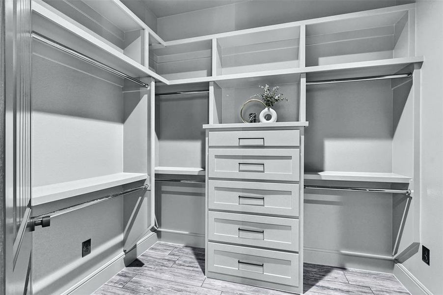Walk in closet with light wood-type flooring Walk in closet with light wood-type flooring