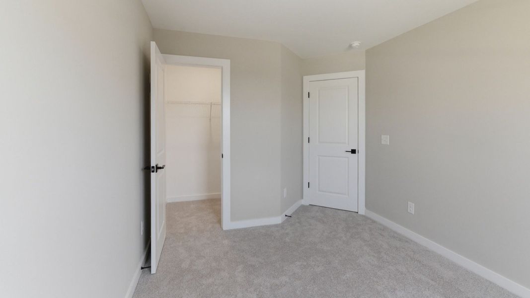 Bedroom with carpet and closet Bedroom with carpet and closet