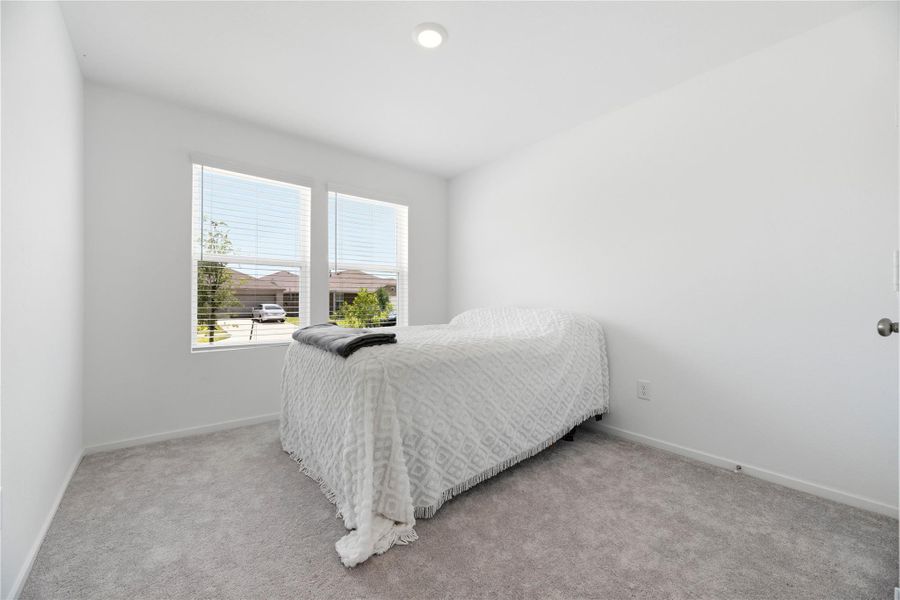 Spacious secondary bedrooms with plush carpet and ample closet space.