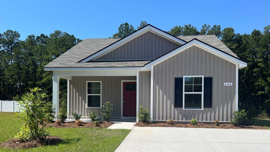 Front exterior of a new home in Sandpiper Place, Myrtle Beach, SC, highlighting curb appeal (Image 1).